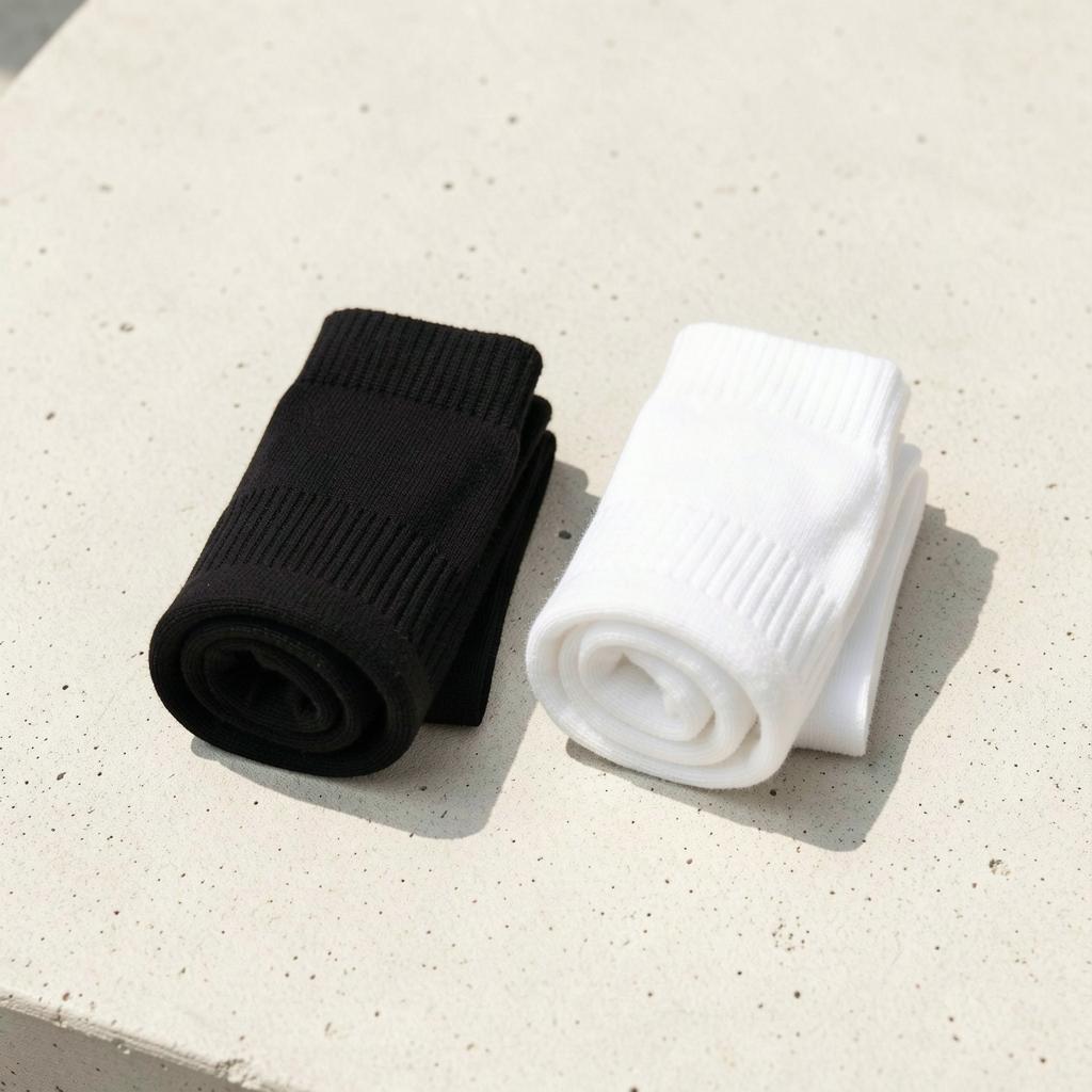 Rolled black and white crew socks side by side