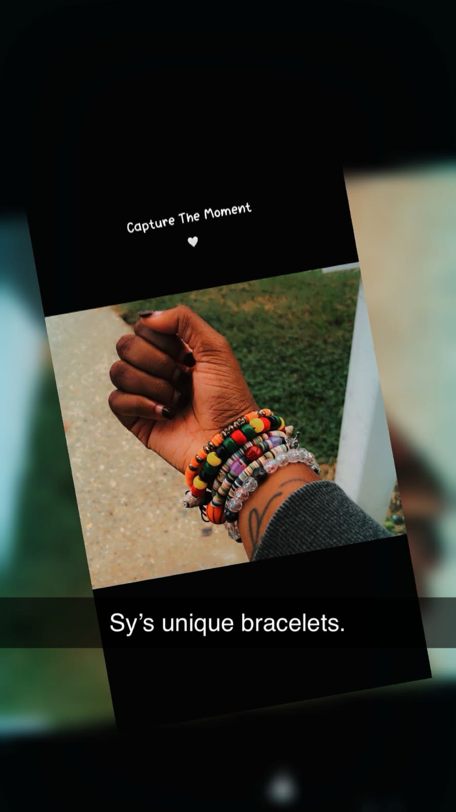 Sy’s handmade beaded bracelets stacked on her wrist — “Capture The Moment”