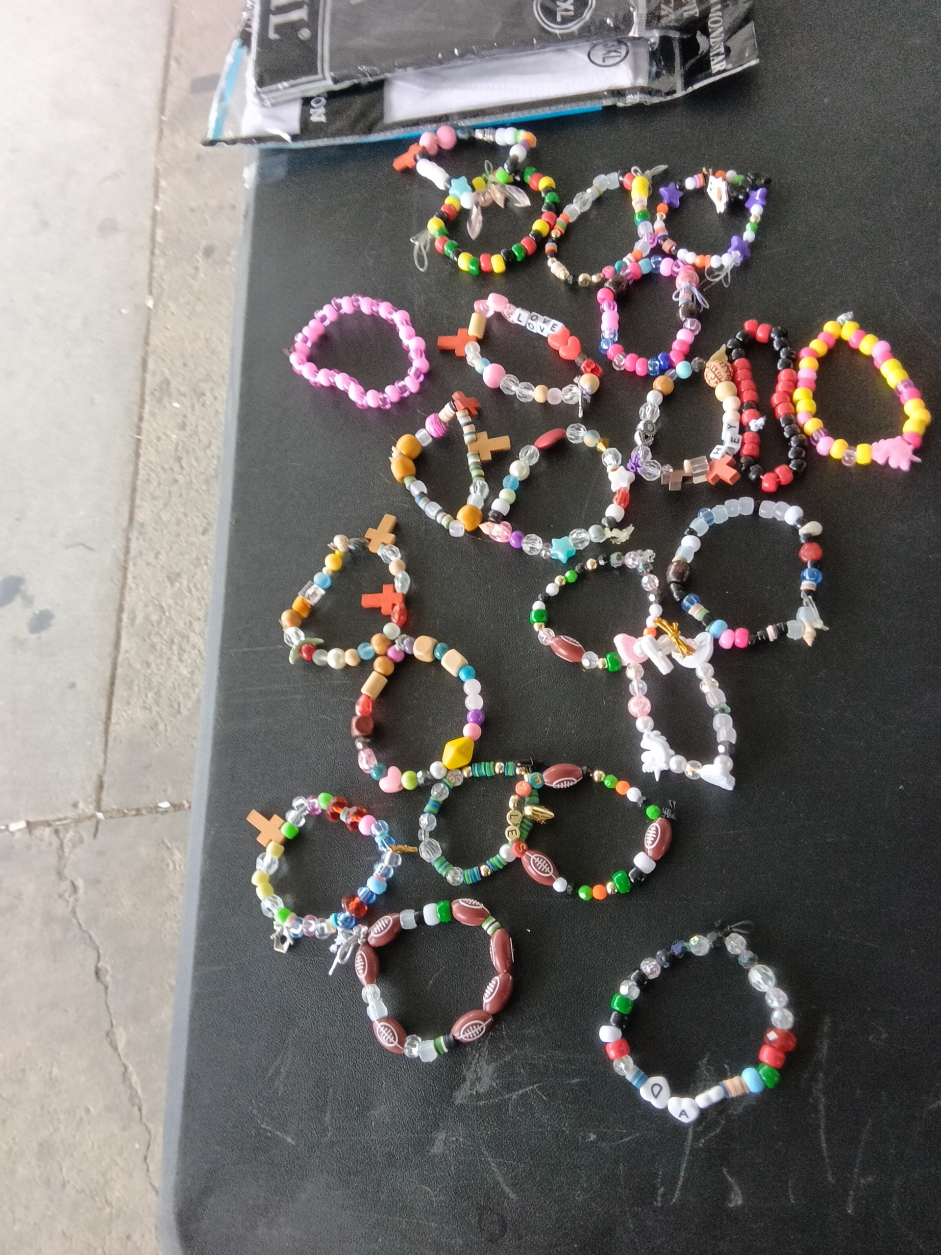 An assortment of Sy’s handmade beaded bracelets on the table